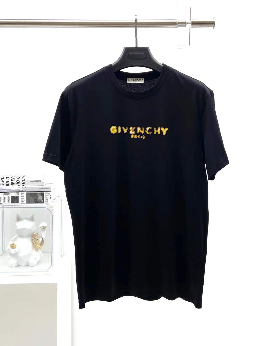 Givenchy black cotton T-shirt featuring a distinctive distressed gold logo print on the chest