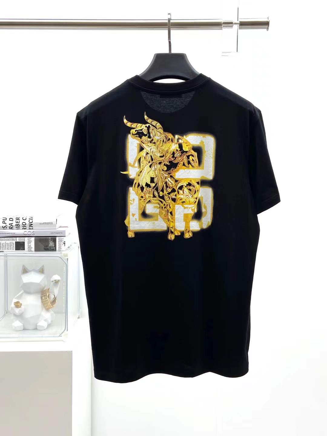 Givenchy black cotton T-shirt featuring a distinctive distressed gold logo print on the chest