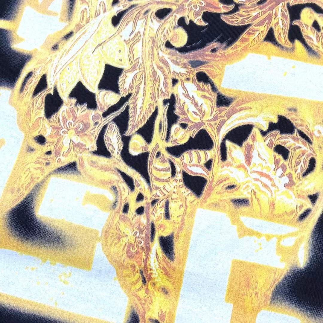 Givenchy black cotton T-shirt featuring a distinctive distressed gold logo print on the chest