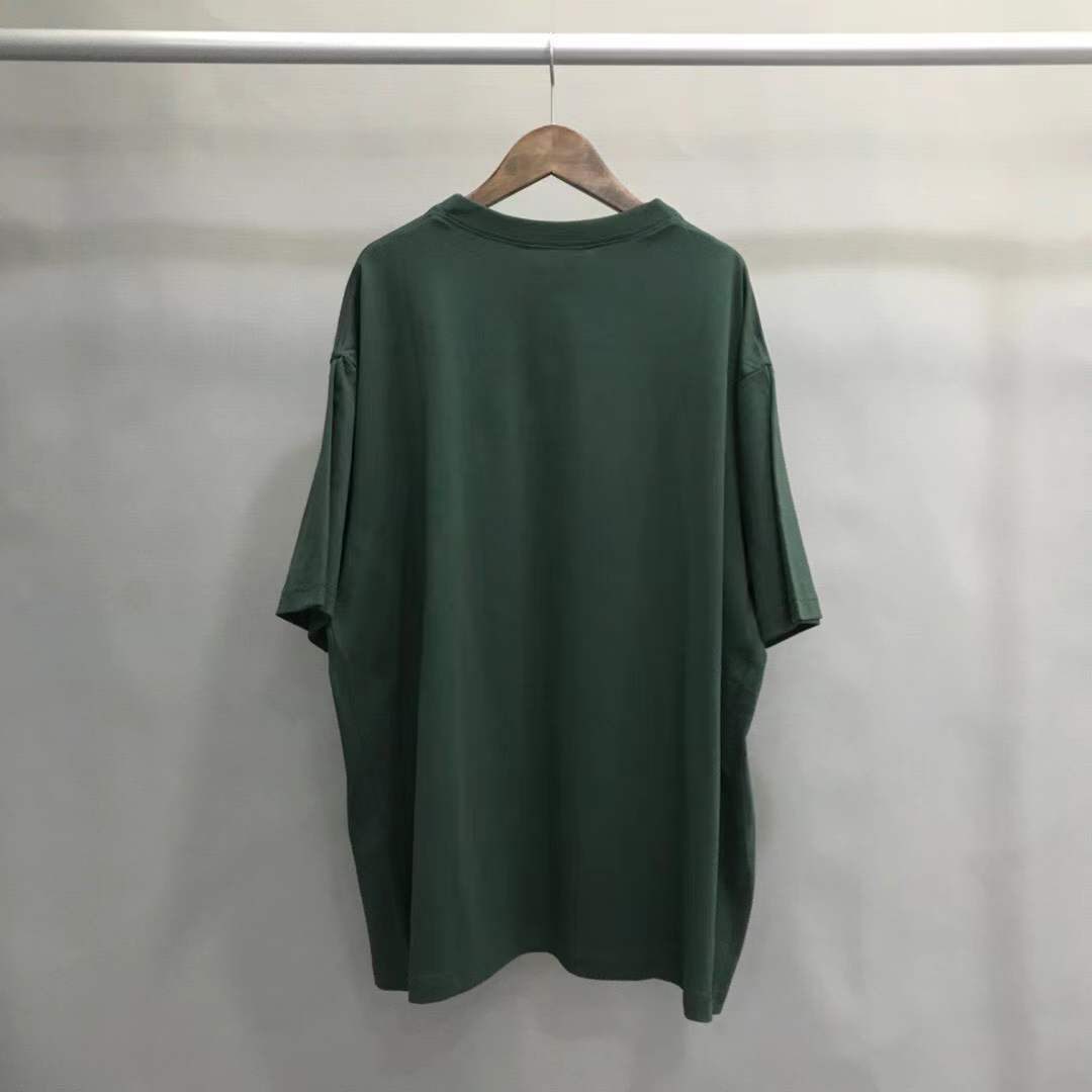 Balenciaga Unisex-Print Large Fit T-shirt in Green features "UNIS3X" text on the front.