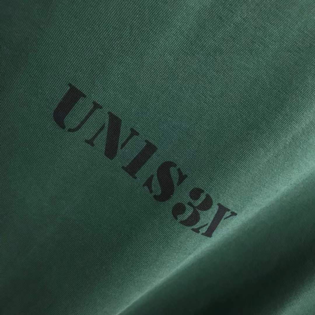 Balenciaga Unisex-Print Large Fit T-shirt in Green features "UNIS3X" text on the front.