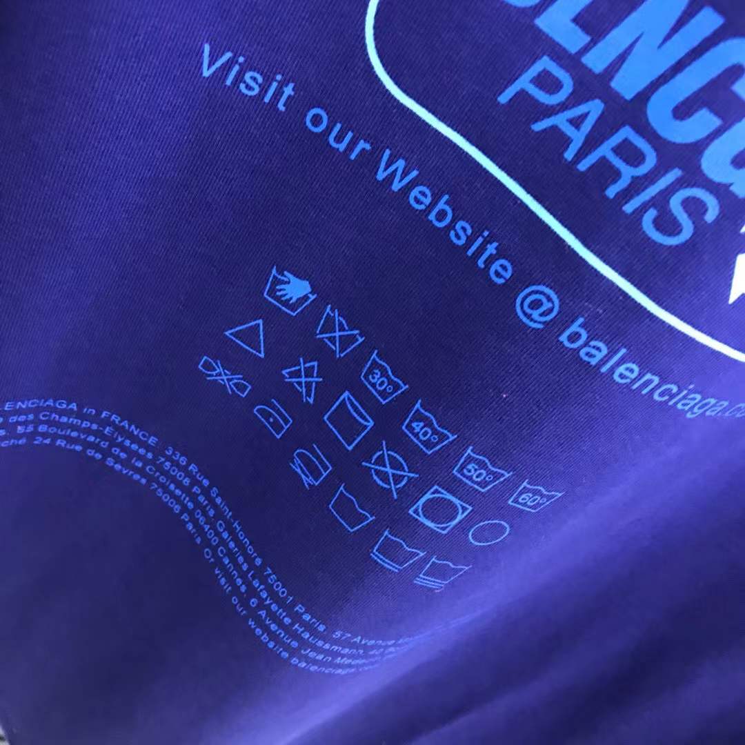 Balenciaga Dry Cleaning Boxy T-Shirt in blue cotton features a short-sleeved, crewneck design with a printed motif on the front