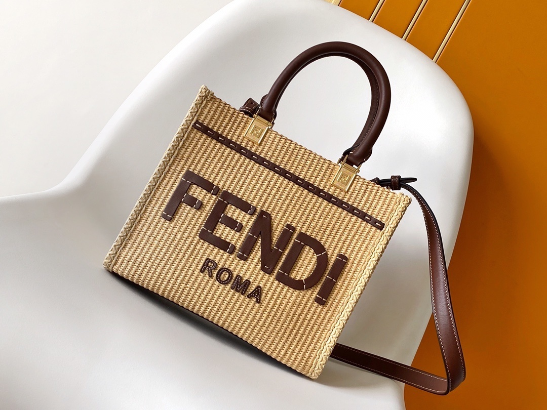 Fendi Sunshine tote bag is crafted from beige natural fiber raffia with brown leather trim and prominent "Fendi Roma" lettering