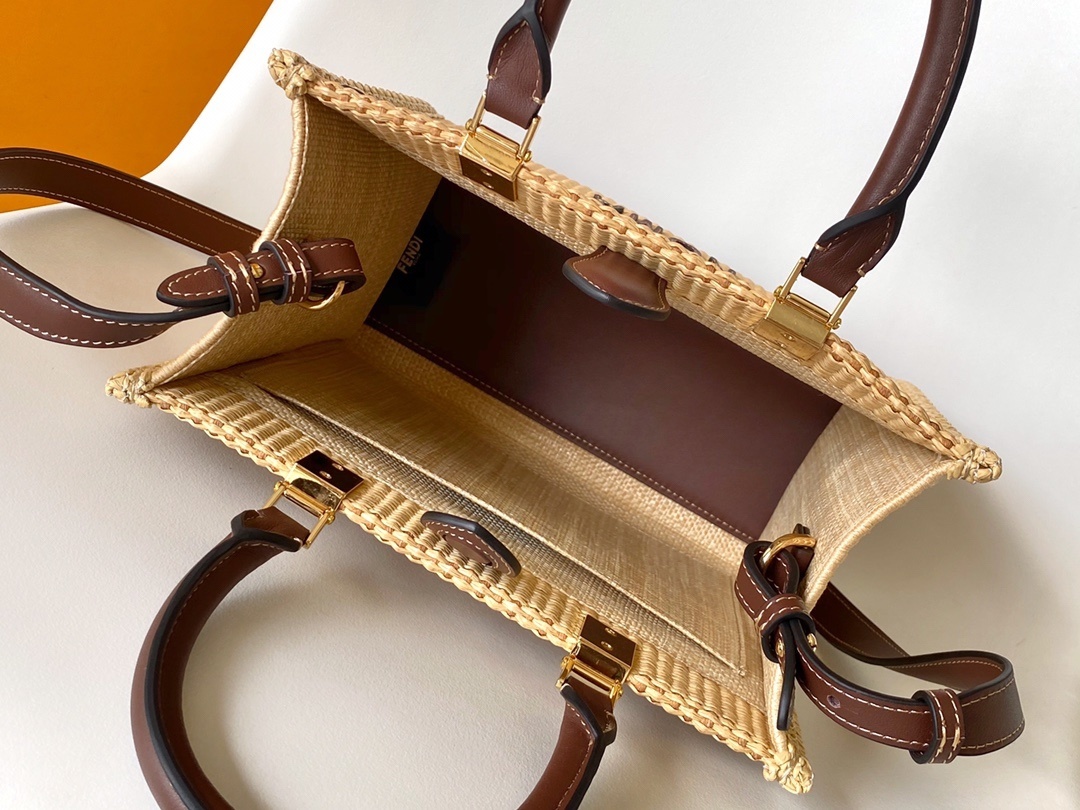 Fendi Sunshine tote bag is crafted from beige natural fiber raffia with brown leather trim and prominent "Fendi Roma" lettering