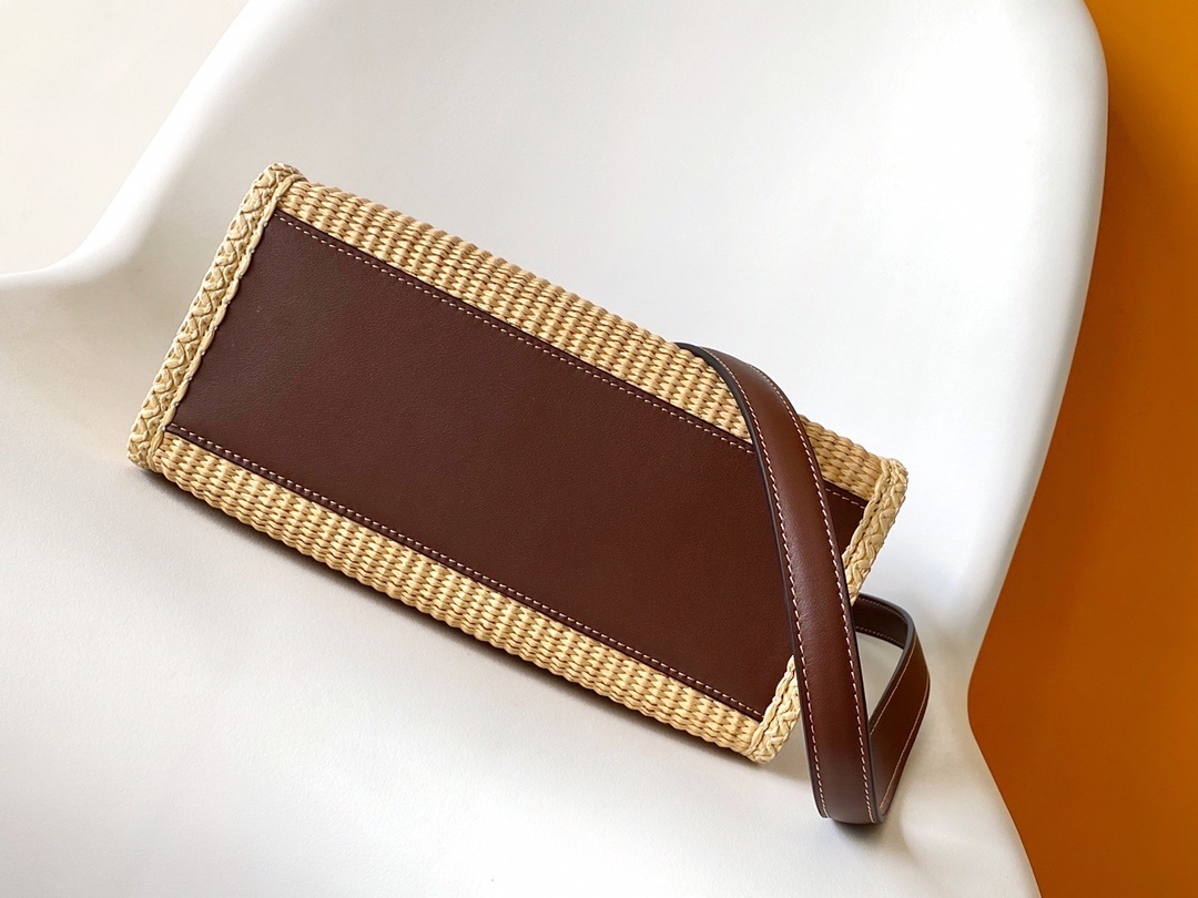 Fendi Sunshine tote bag is crafted from beige natural fiber raffia with brown leather trim and prominent "Fendi Roma" lettering