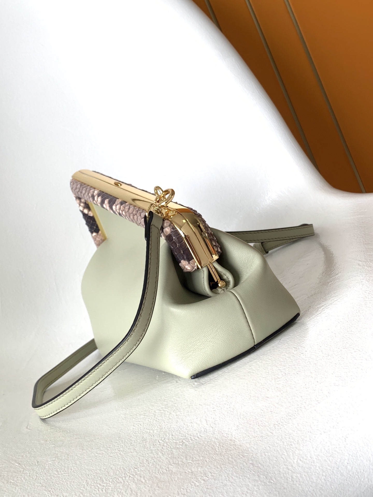 Fendi Avocado Green Leather and Python Small First Clutch, featuring an iconic oversized 'F' clasp and a detachable shoulder strap