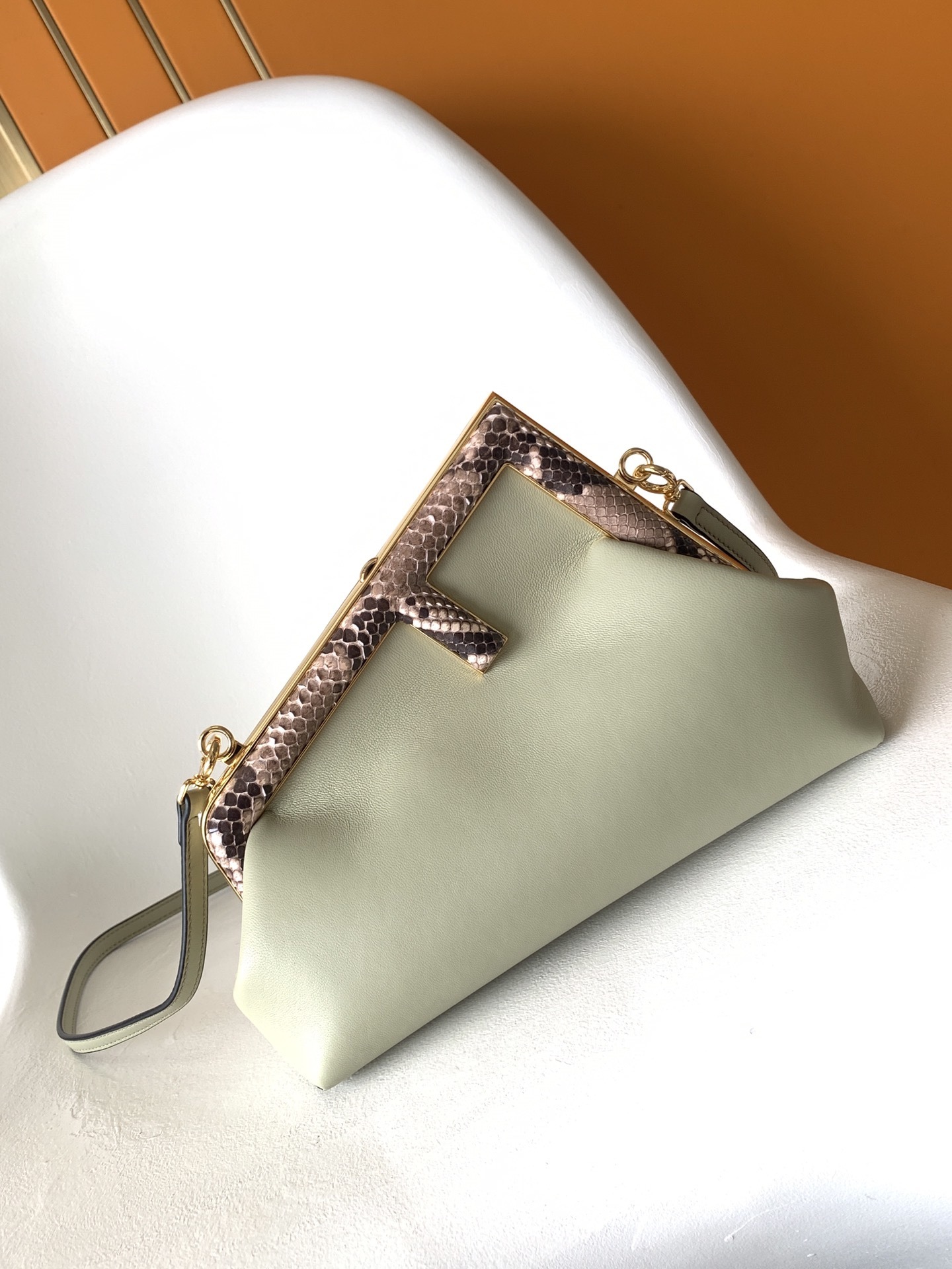 Fendi Avocado Green Leather and Python Small First Clutch, featuring an iconic oversized 'F' clasp and a detachable shoulder strap