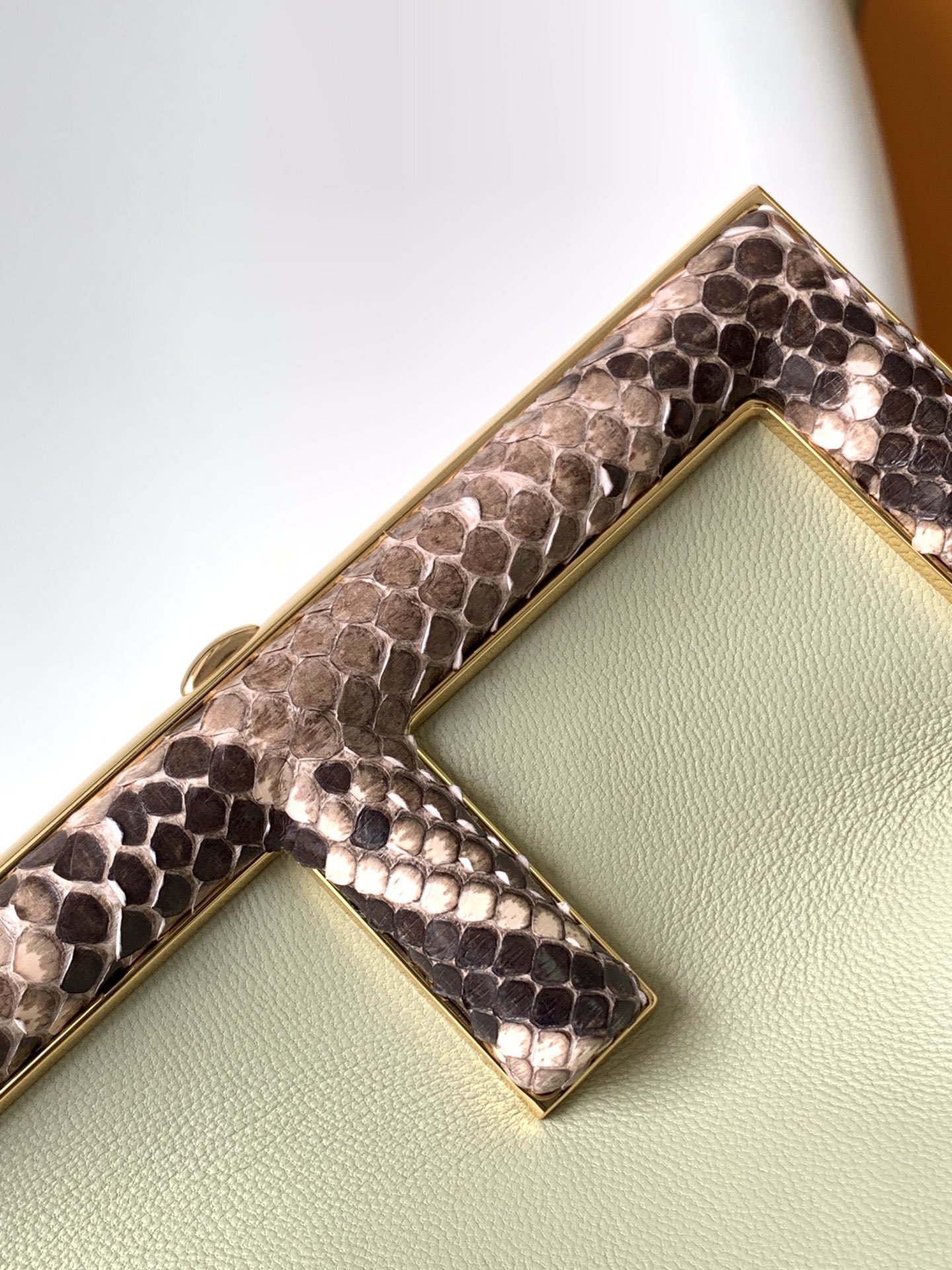Fendi Avocado Green Leather and Python Small First Clutch, featuring an iconic oversized 'F' clasp and a detachable shoulder strap