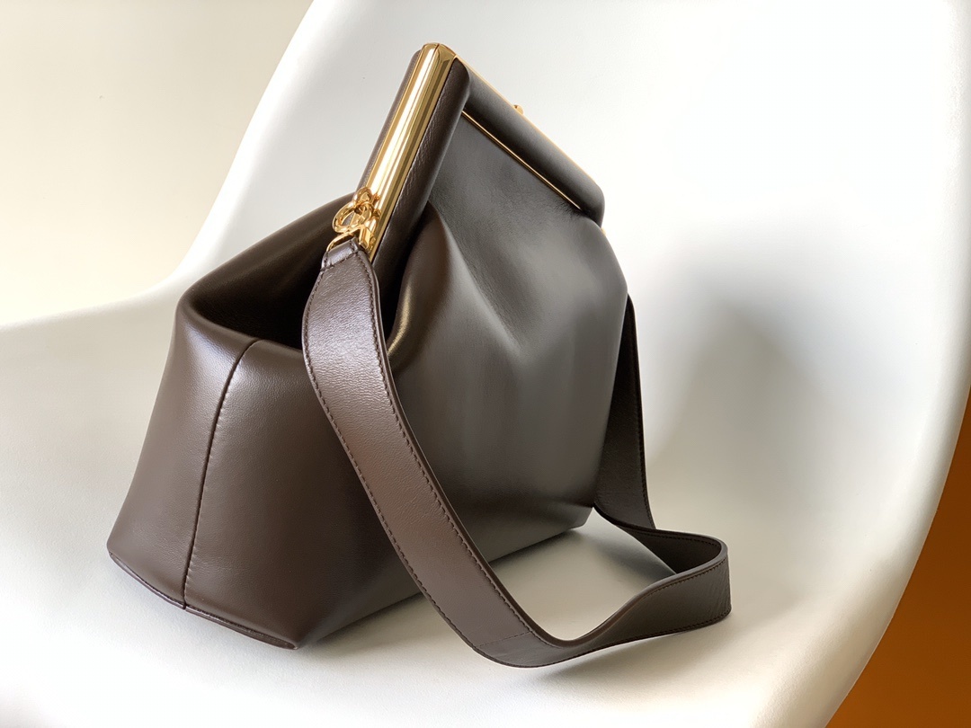 Fendi First Medium Shoulder Bag, which features a distinctive oversized metal 'F' clasp and a detachable shoulder strap
