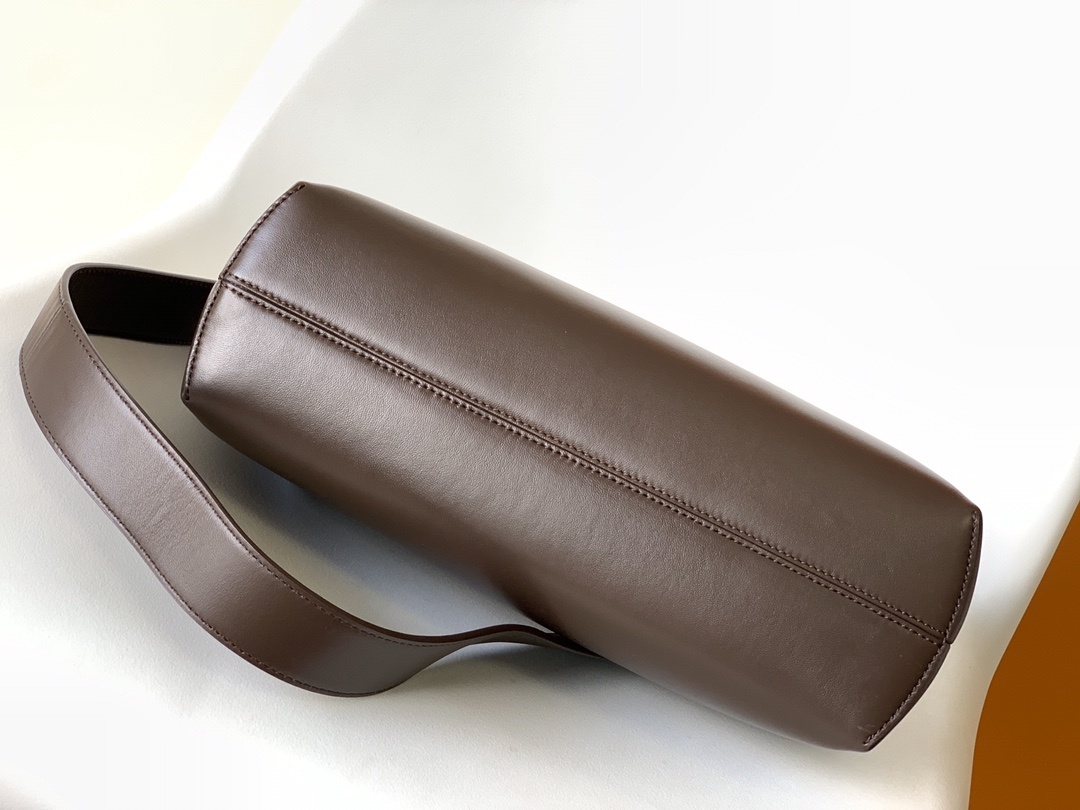 Fendi First Medium Shoulder Bag, which features a distinctive oversized metal 'F' clasp and a detachable shoulder strap