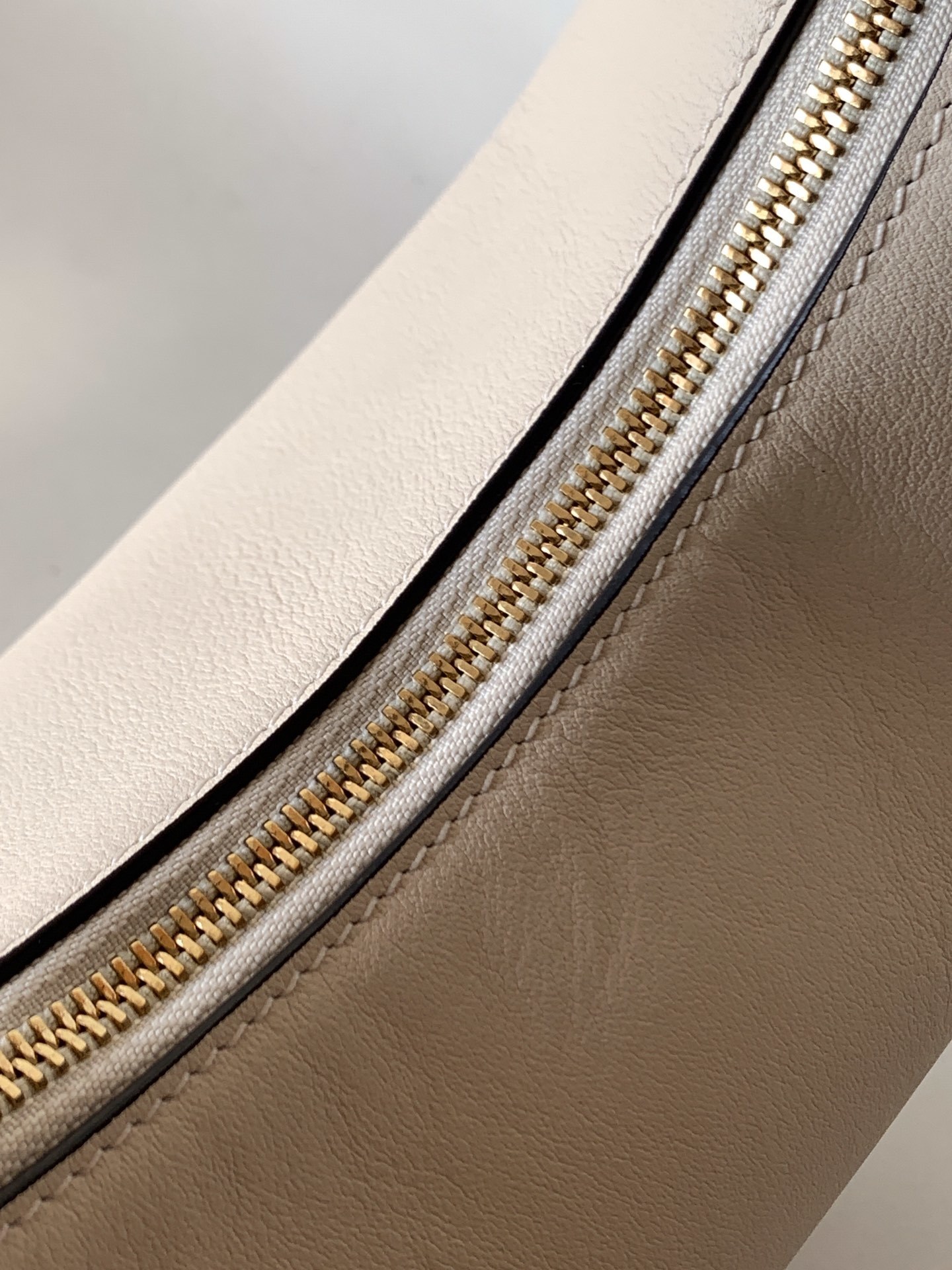 Fendi Fendigraphy leather shoulder bag often referred to as a hobo bag, featuring gold-tone metal hardware.