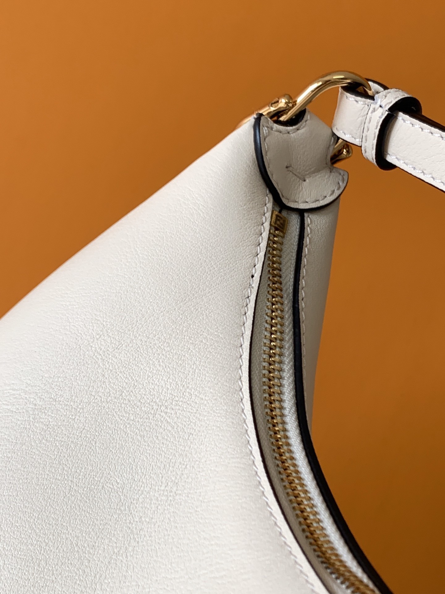 Fendi Fendigraphy leather shoulder bag often referred to as a hobo bag, featuring gold-tone metal hardware.