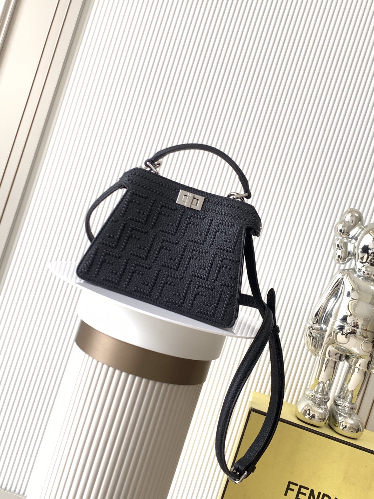 Fendi Peekaboo bag specifically appearing to be a small model in black with a textured monogram pattern