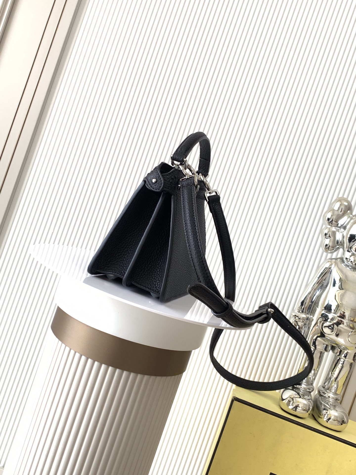 Fendi Peekaboo bag specifically appearing to be a small model in black with a textured monogram pattern