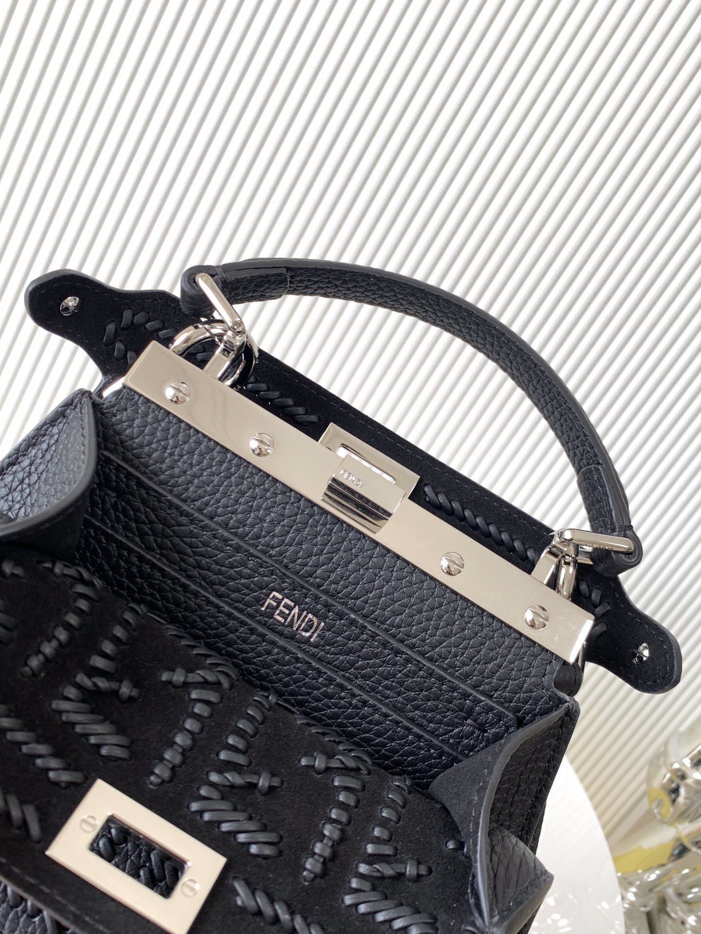 Fendi Peekaboo bag specifically appearing to be a small model in black with a textured monogram pattern