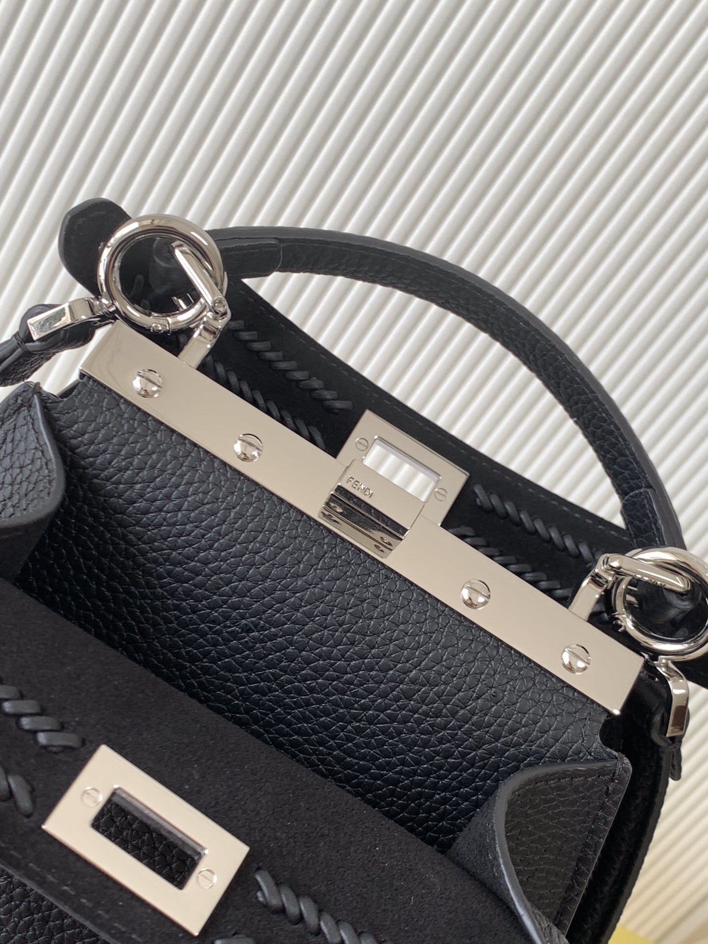 Fendi Peekaboo bag specifically appearing to be a small model in black with a textured monogram pattern