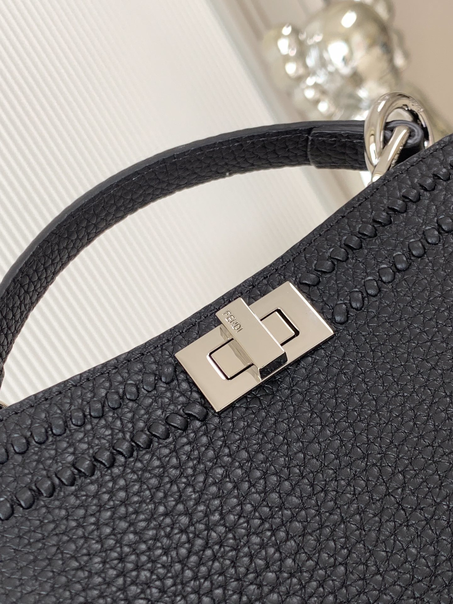 Fendi Peekaboo bag specifically appearing to be a small model in black with a textured monogram pattern