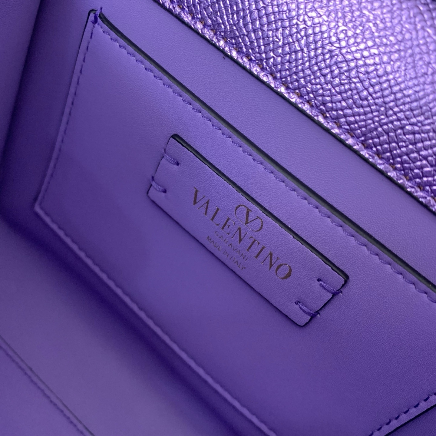 Valentino Garavani Vsling Mini Top-Handle Bag in purple metallic grainy calfskin with antique brass hardware
