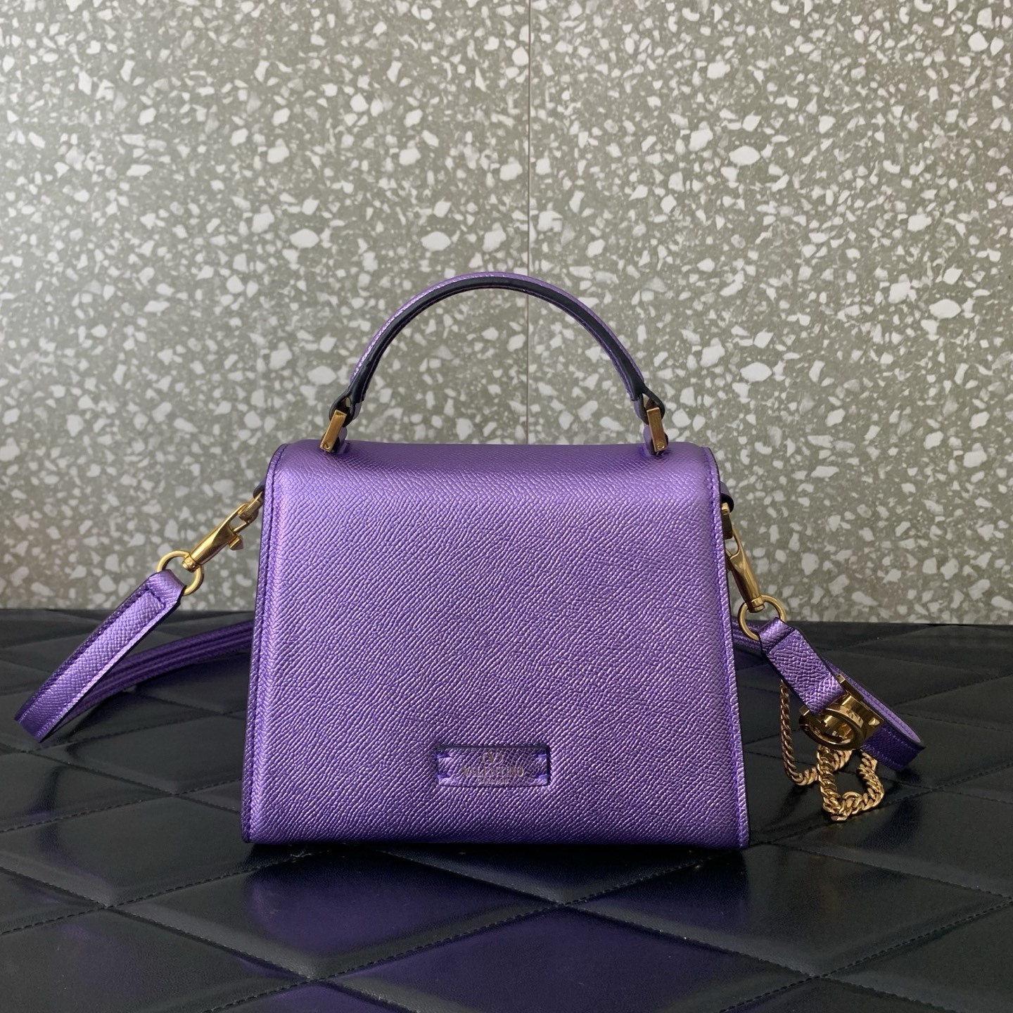 Valentino Garavani Vsling Mini Top-Handle Bag in purple metallic grainy calfskin with antique brass hardware