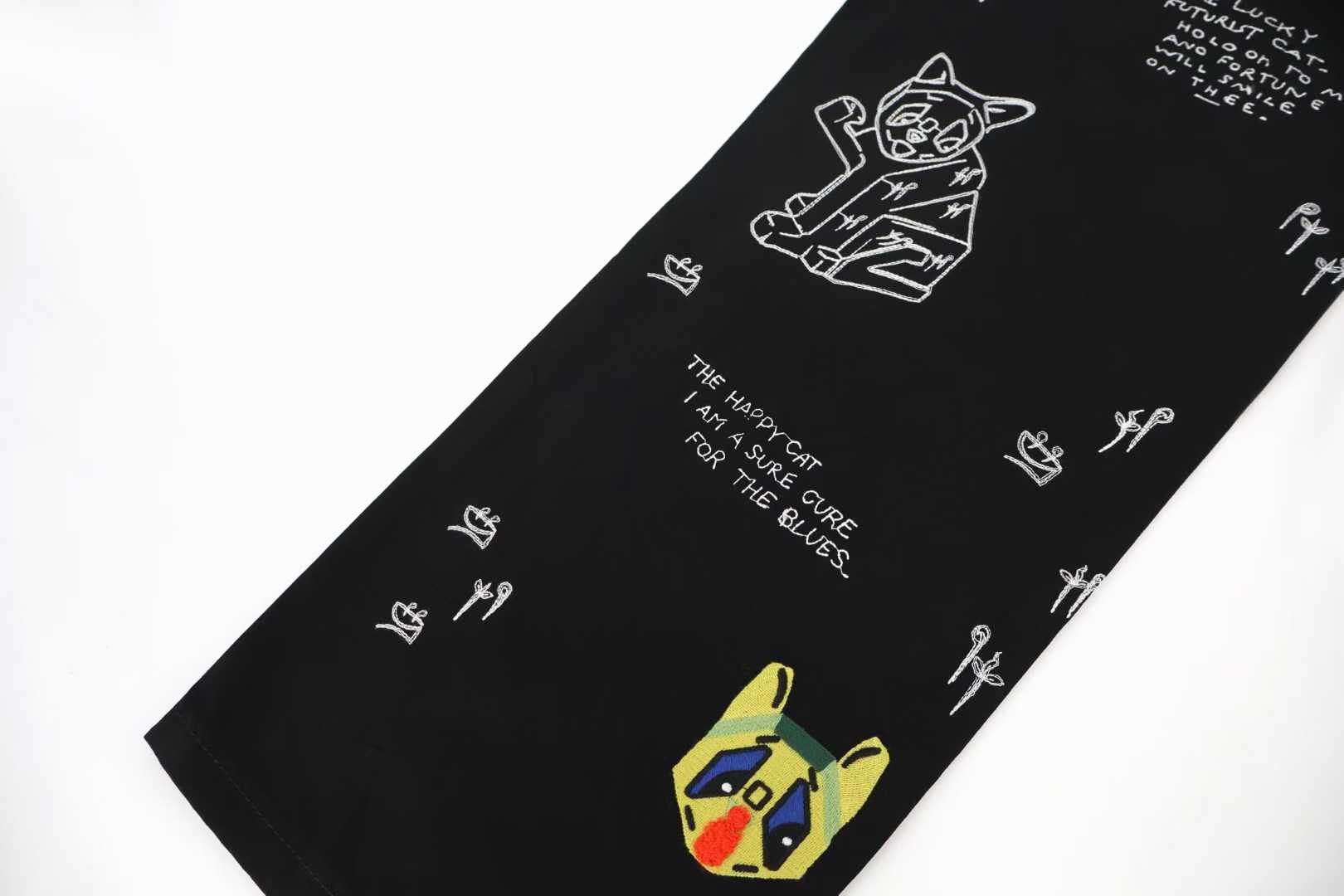 Loewe x Louis Wain embroidered wide-leg jeans in black, featuring playful animal appliqués inspired by the British artist's "Futurist Cats" series