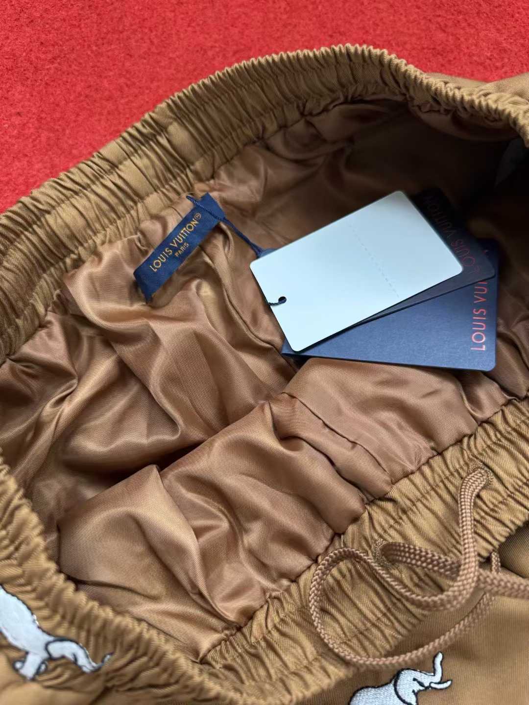 LV x The Darjeeling Limited Fil Coupe drawstring pants featuring an all-over motif