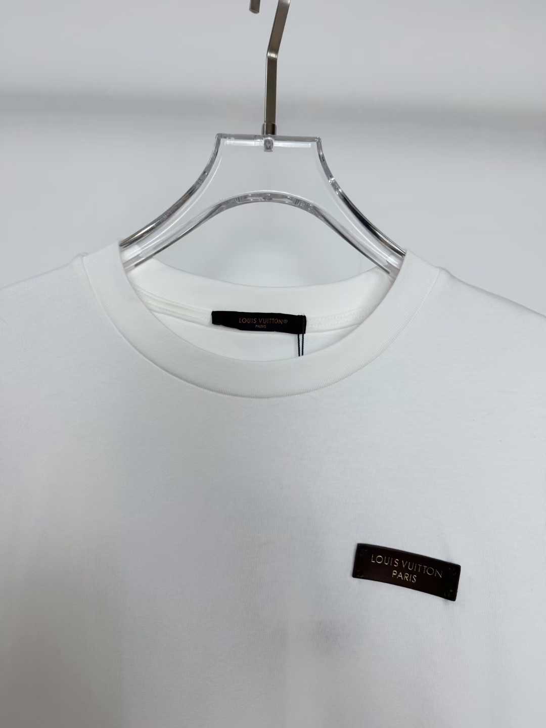 LV white cotton T-shirt featuring a branded metal logo plaque on the chest