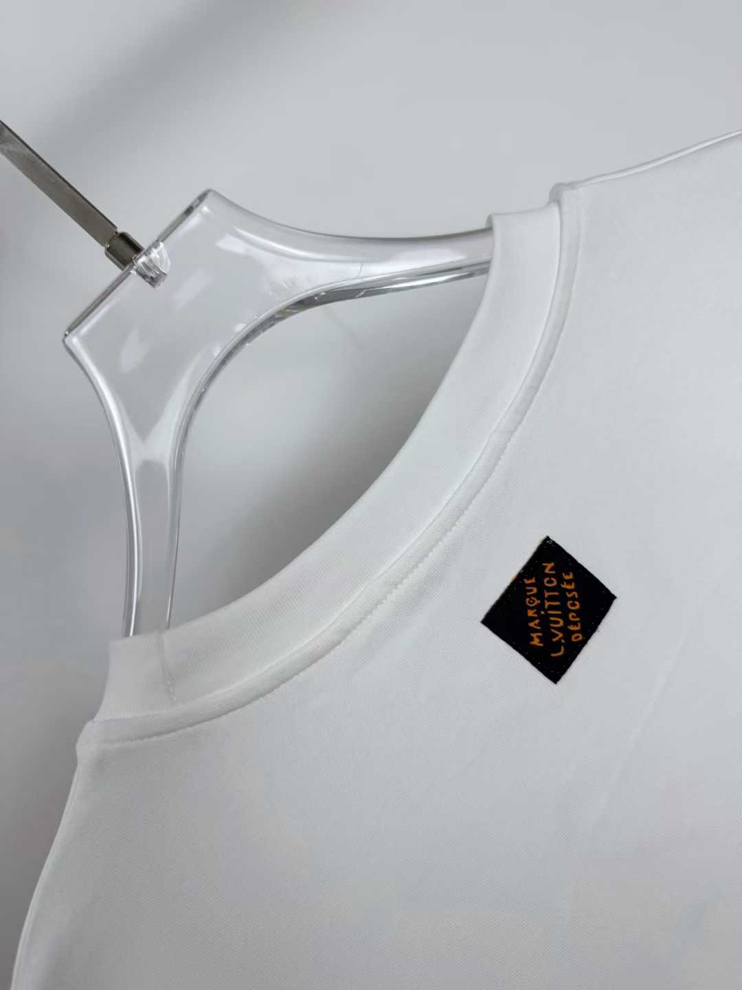LV white cotton T-shirt featuring a branded metal logo plaque on the chest
