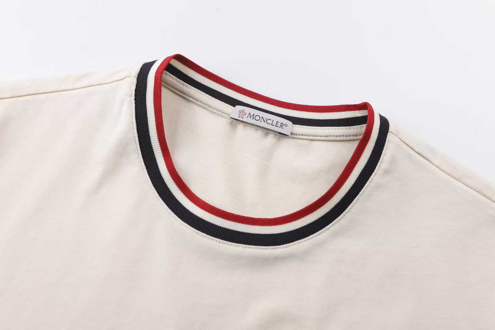 Moncler striped-collar T-shirt featuring a distinctive MonDuck logo patch