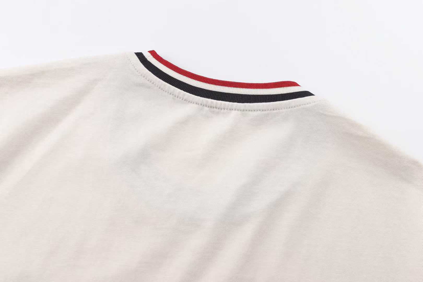 Moncler striped-collar T-shirt featuring a distinctive MonDuck logo patch