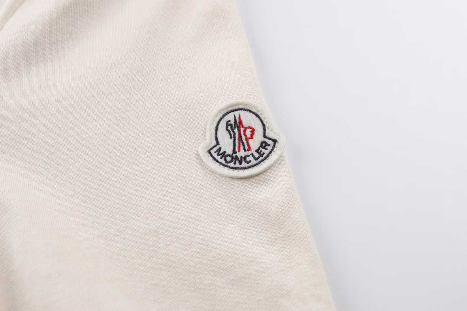 Moncler striped-collar T-shirt featuring a distinctive MonDuck logo patch