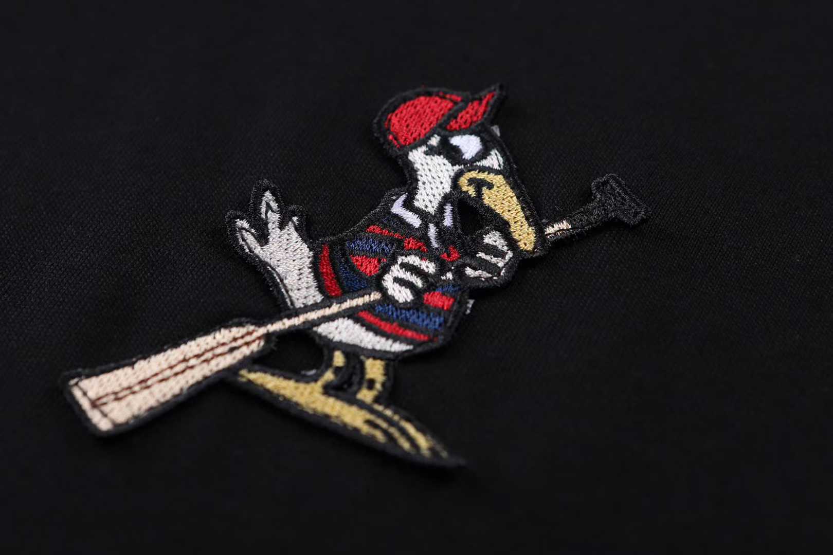 Moncler Striped-Trim Detail-Appliqué T-Shirt is a luxury cotton jersey crewneck featuring a distinctive mascotte logo patch on the chest and striped detailing on the neckline