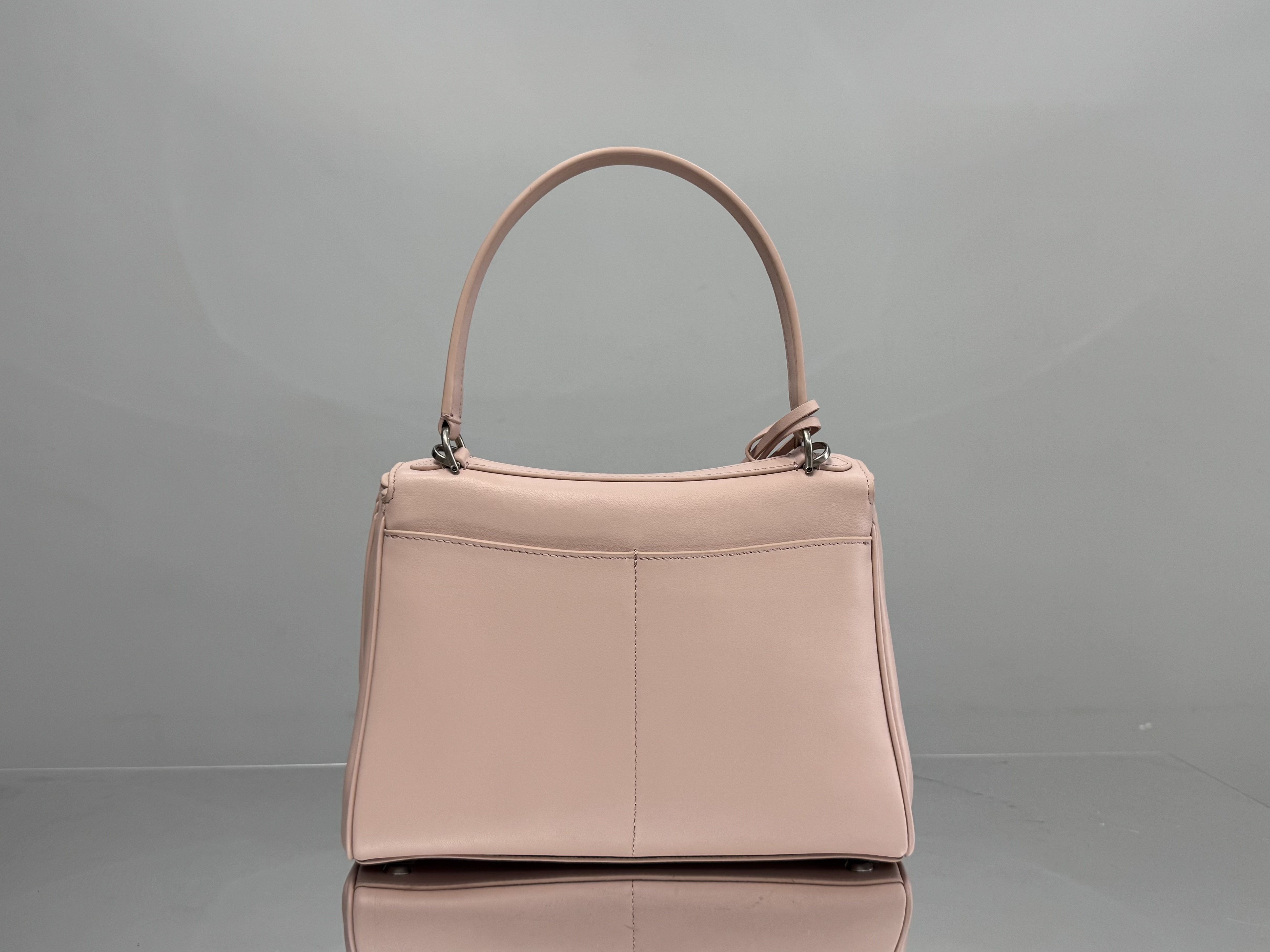 Balenciaga Rodeo handbag likely in a pink or beige calf leather.