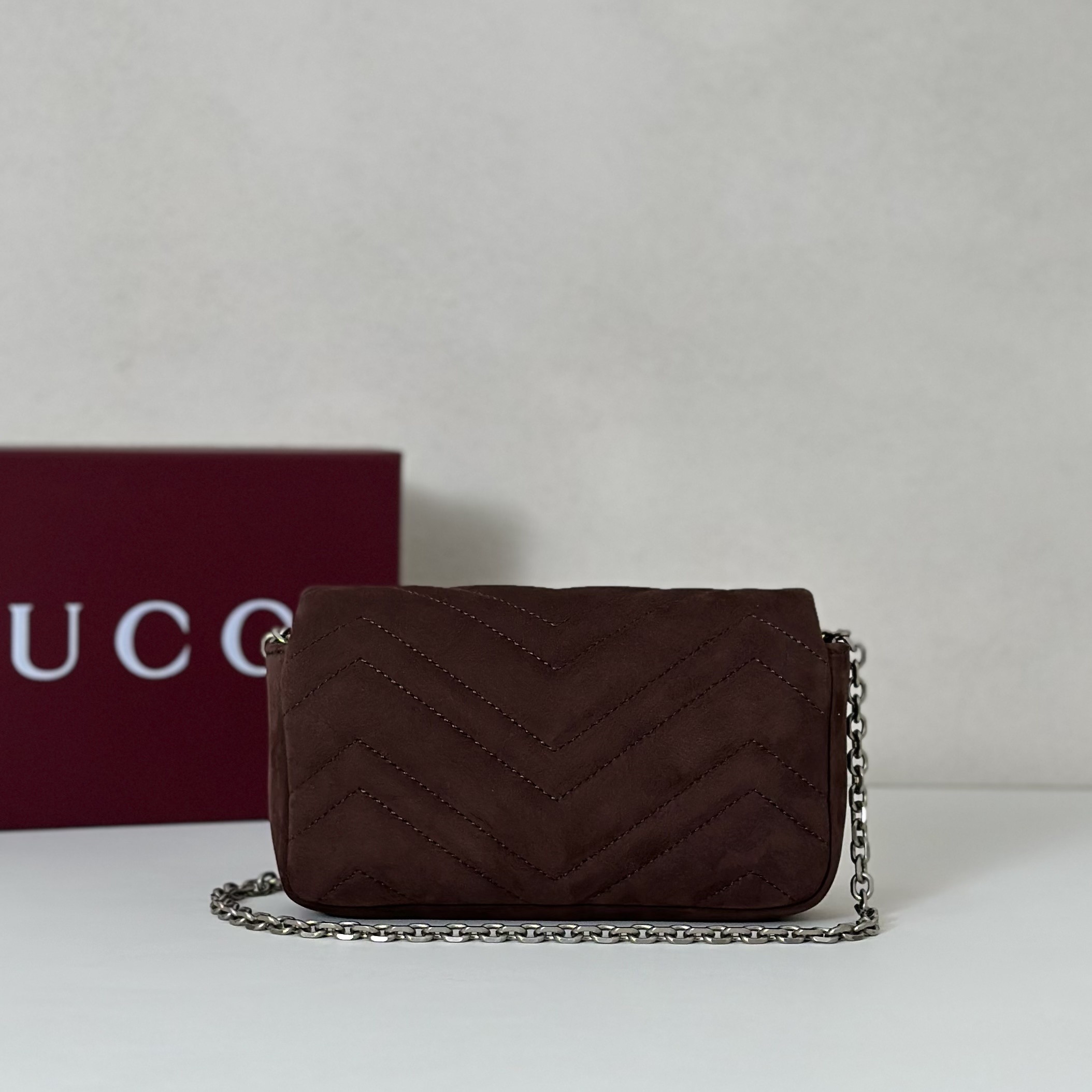 Gucci GG Marmont mini shoulder bag specifically in a brown or burgundy matelassé leather with silver-toned hardware