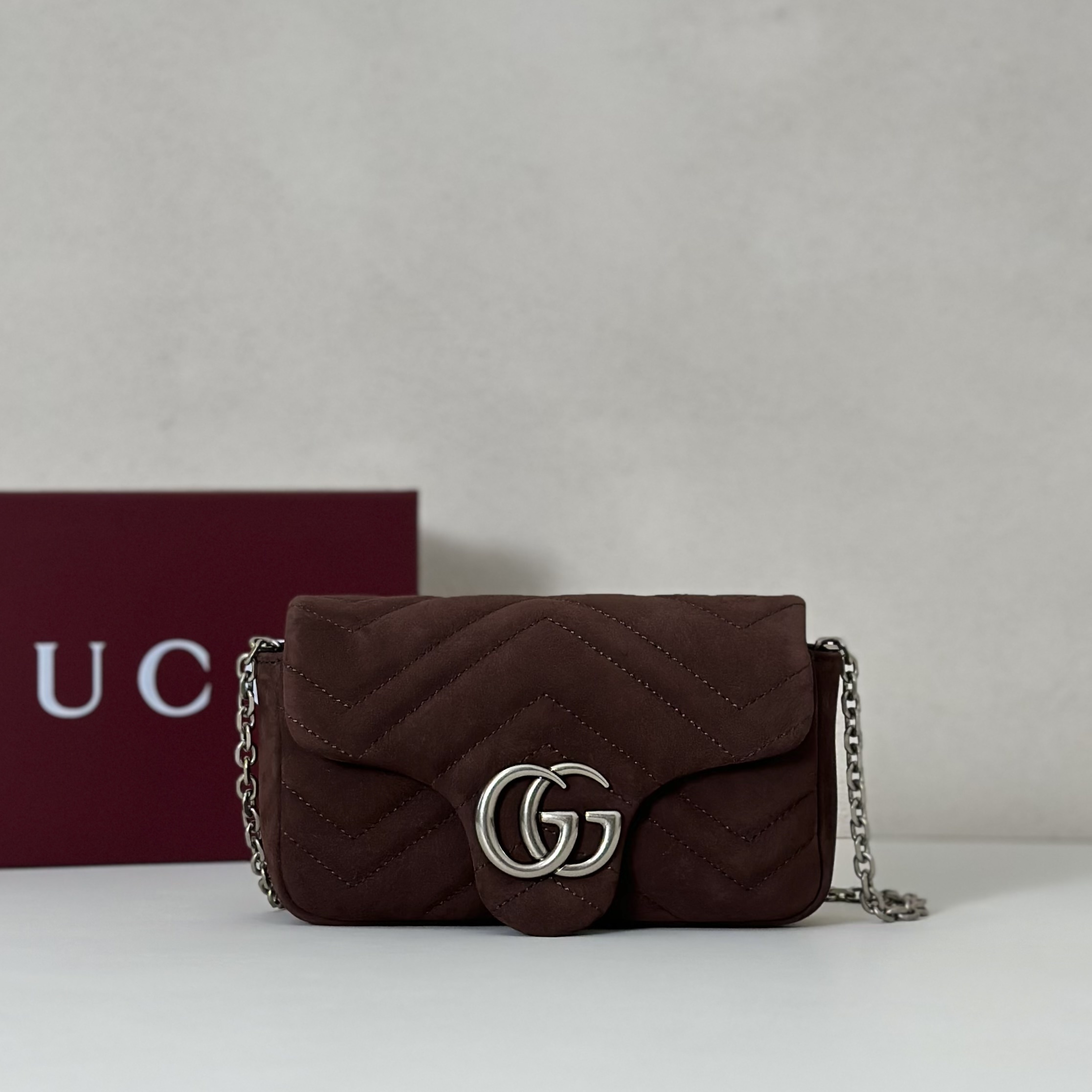 Gucci GG Marmont mini shoulder bag specifically in a brown or burgundy matelassé leather with silver-toned hardware