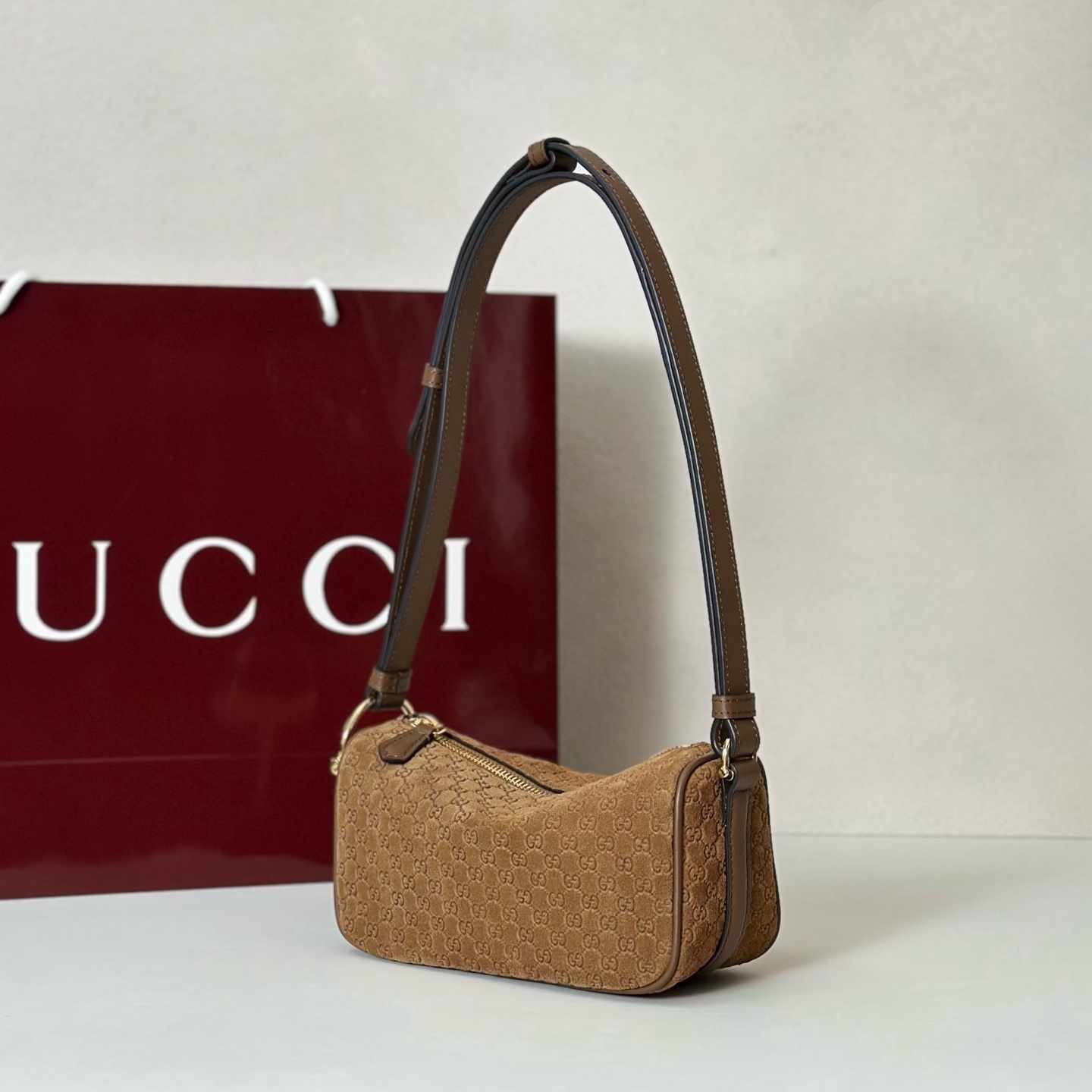 Gucci Half Horsebit mini bag featuring brown suede with a debossed GG pattern.