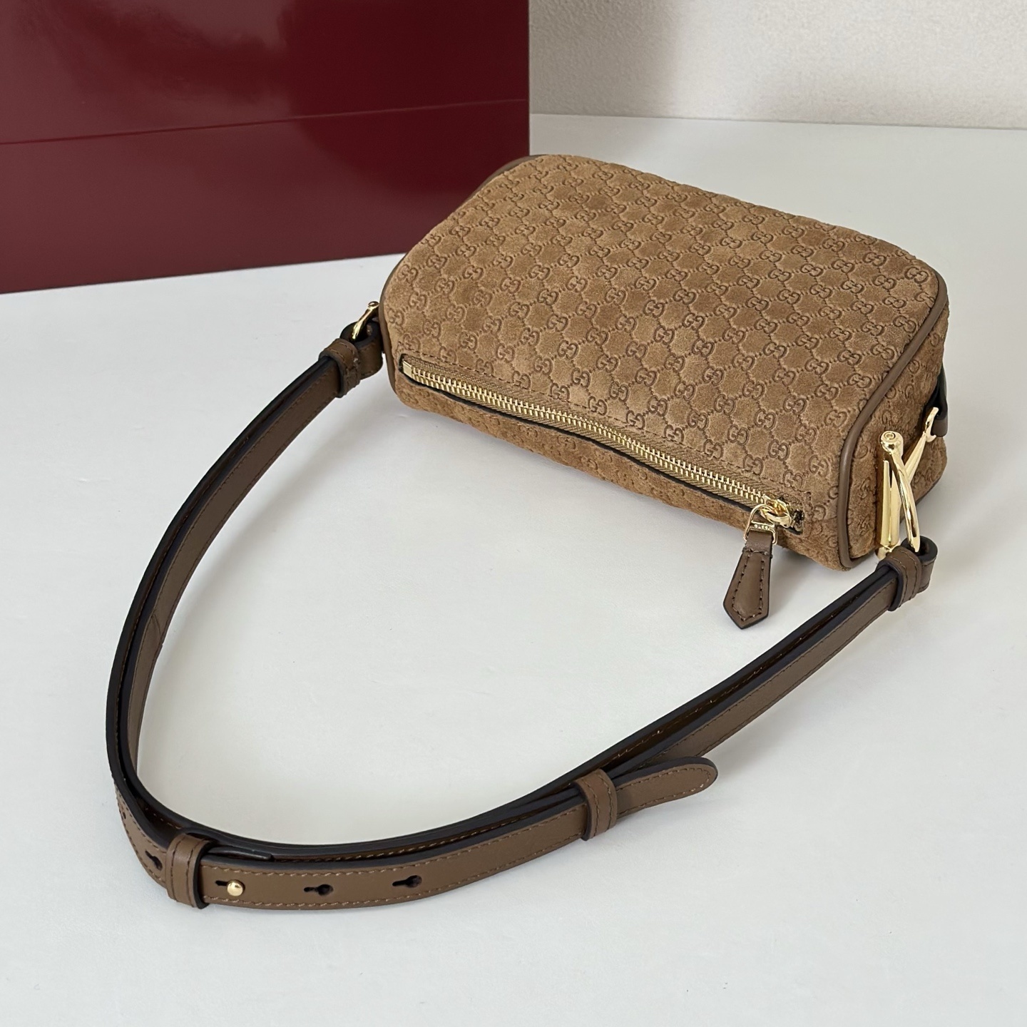 Gucci Half Horsebit mini bag featuring brown suede with a debossed GG pattern.
