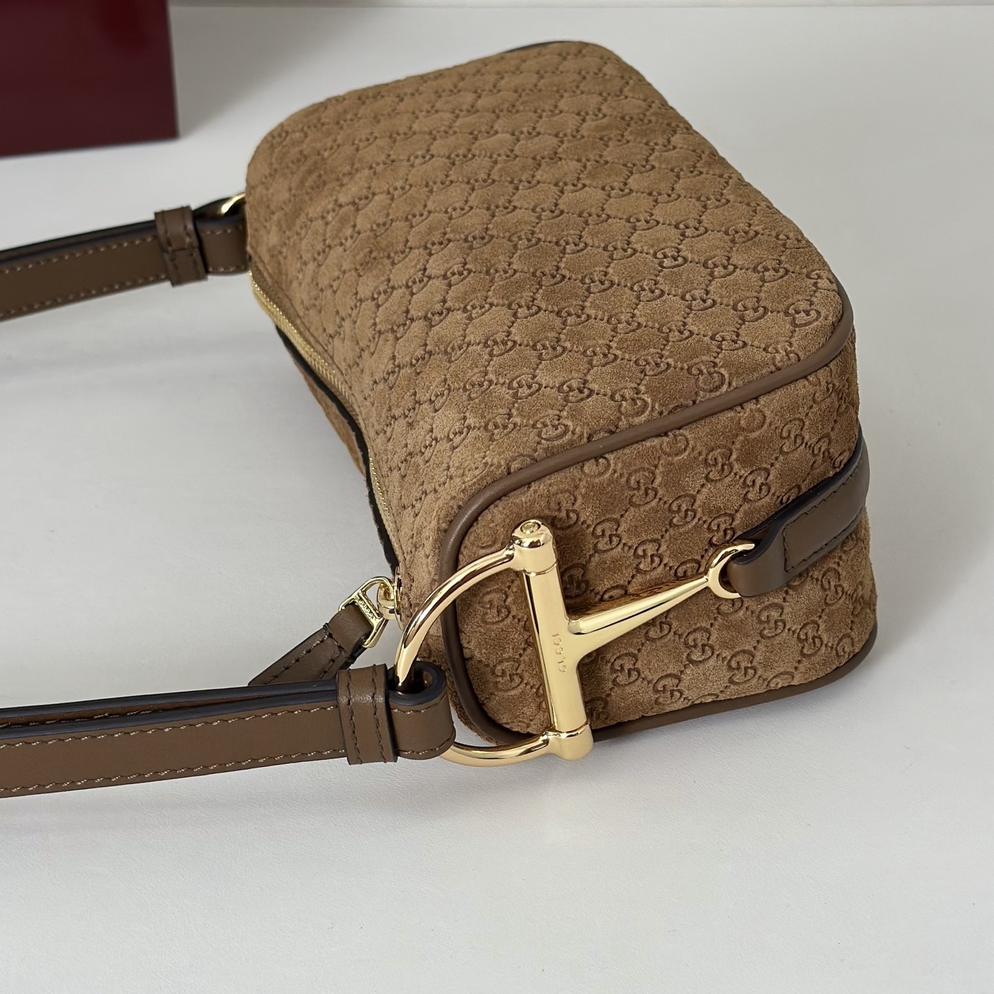 Gucci Half Horsebit mini bag featuring brown suede with a debossed GG pattern.