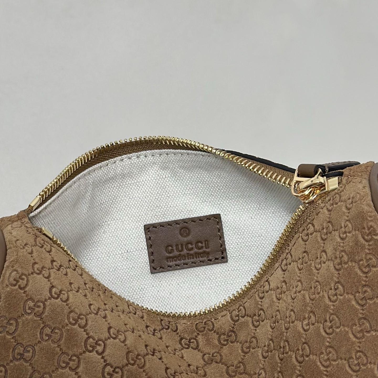 Gucci Half Horsebit mini bag featuring brown suede with a debossed GG pattern.