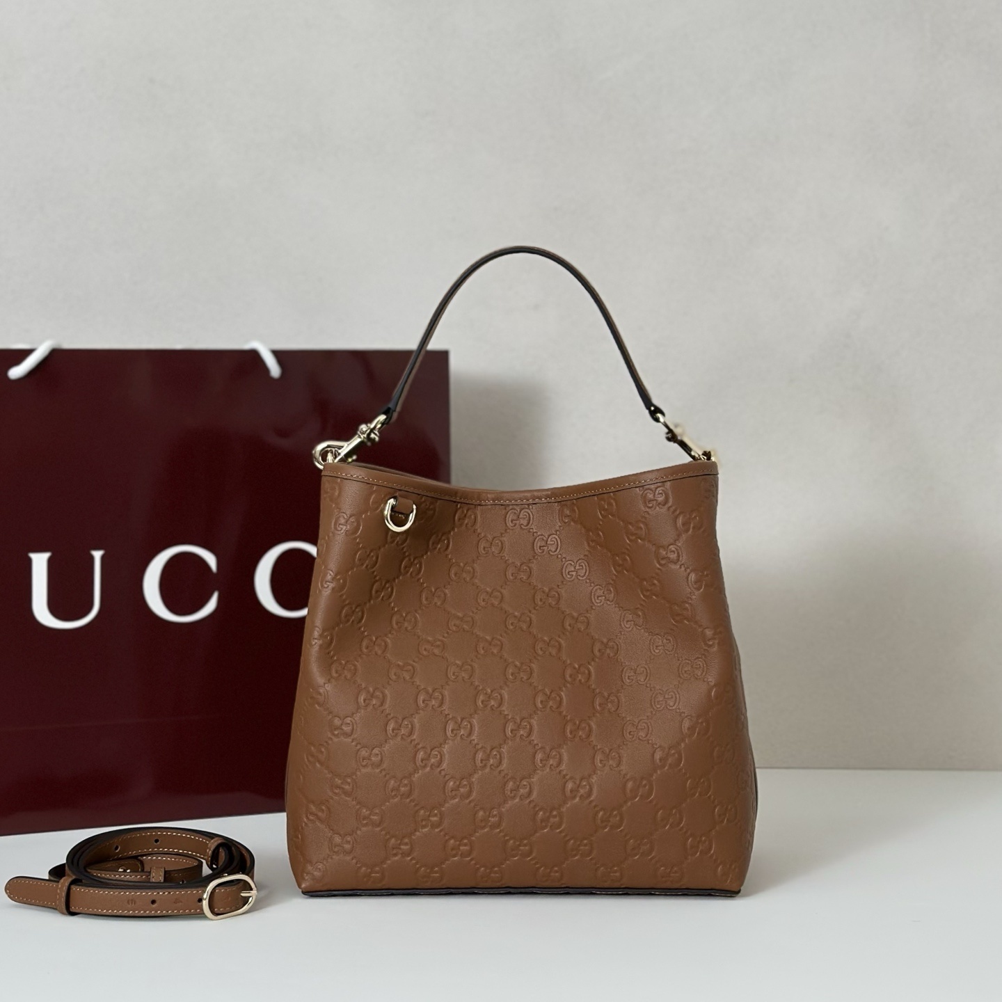 Gucci GG Emblem Small Bucket Bag in brown embossed calfskin