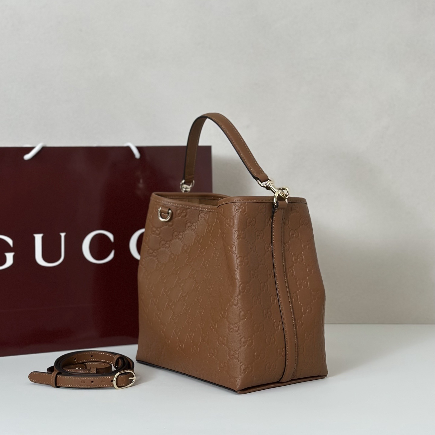 Gucci GG Emblem Small Bucket Bag in brown embossed calfskin