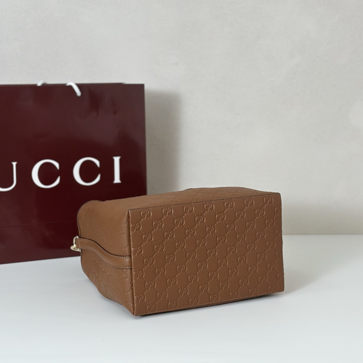 Gucci GG Emblem Small Bucket Bag in brown embossed calfskin