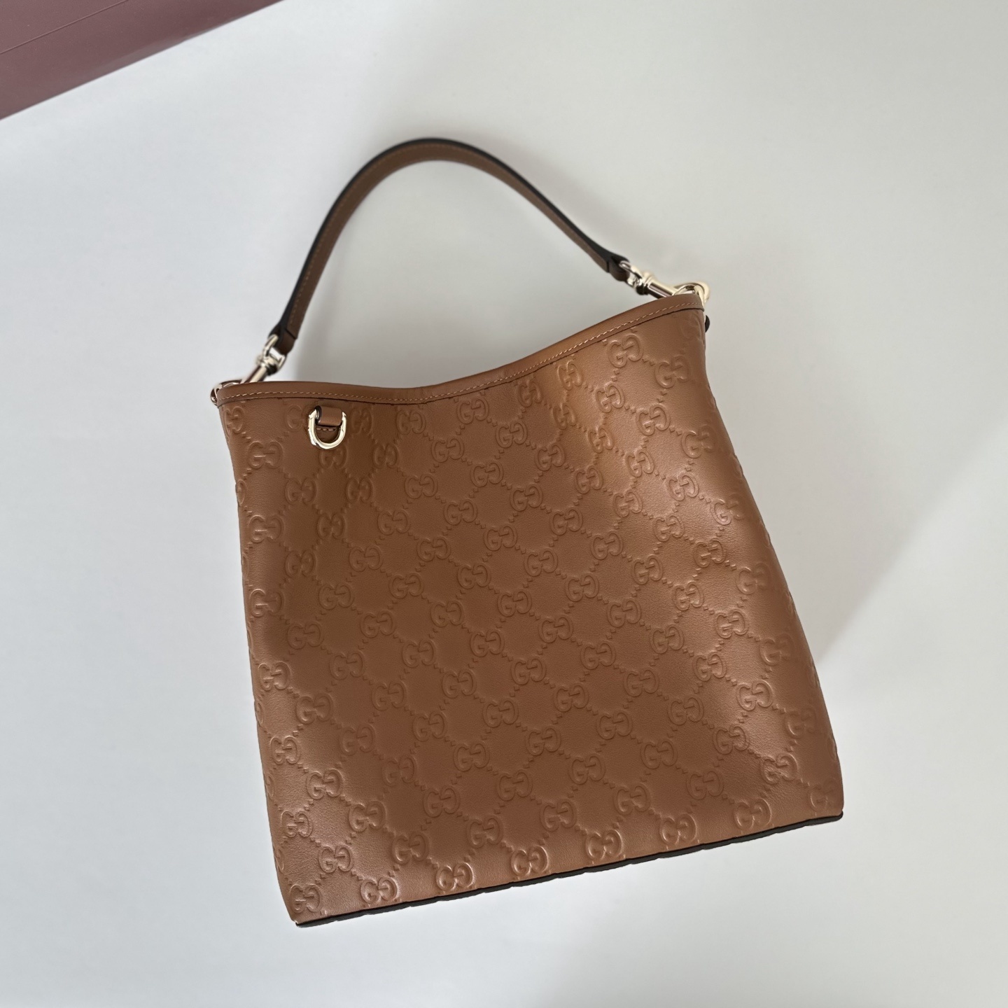 Gucci GG Emblem Small Bucket Bag in brown embossed calfskin