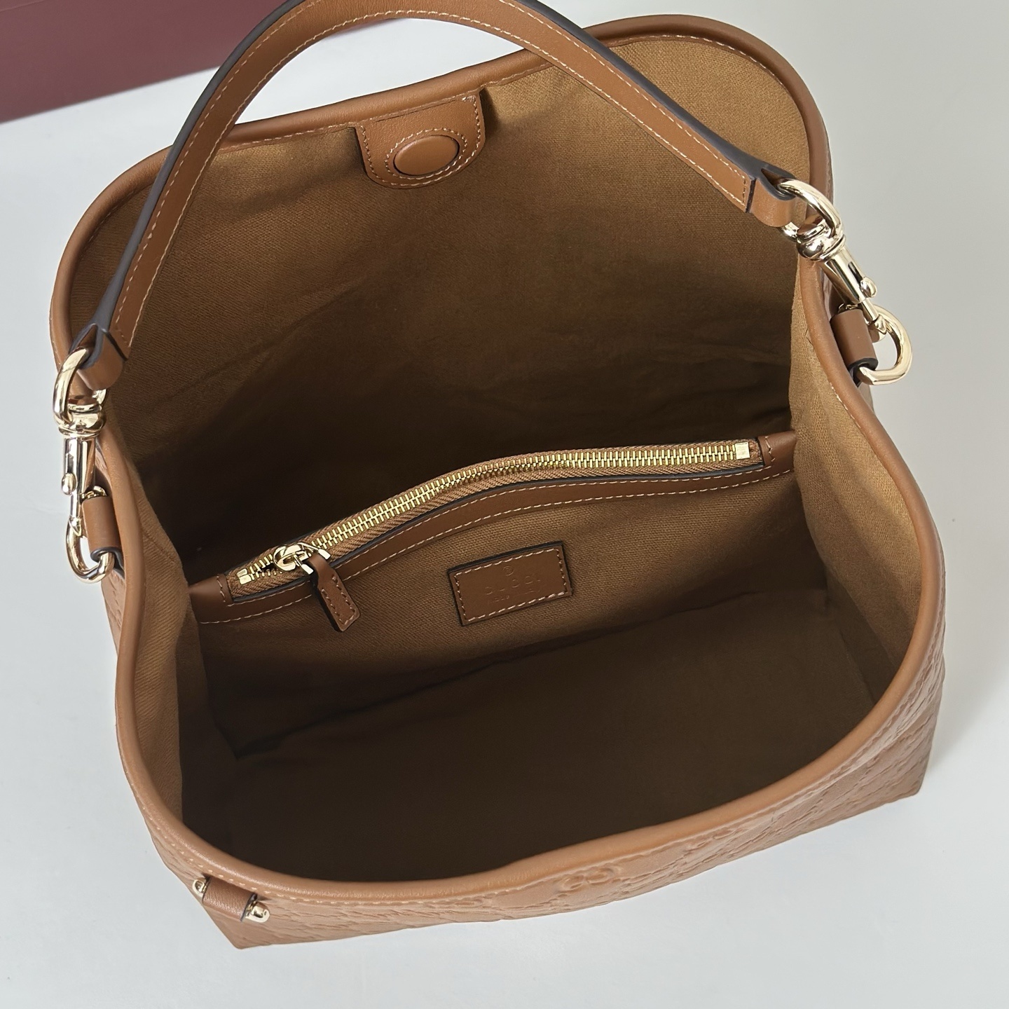 Gucci GG Emblem Small Bucket Bag in brown embossed calfskin